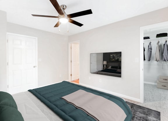 a bedroom with a bed and a ceiling fan at Caveness Farms Apartments, North Carolina, 27587