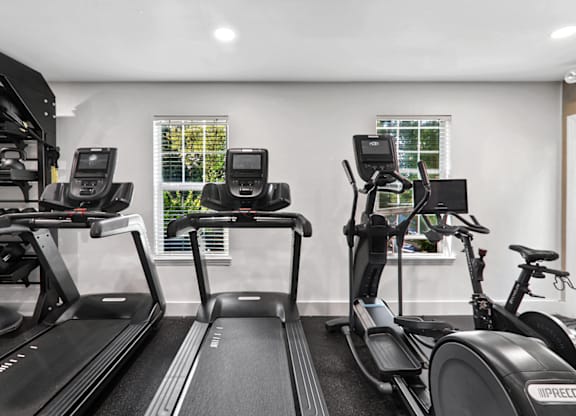 a gym with treadmills and exercise bikes at Caveness Farms Apartments, Wake Forest North Carolina 