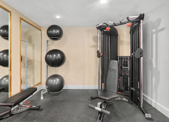 a home gym with exercise equipment and weights at Caveness Farms Apartments, Wake Forest, 27587 