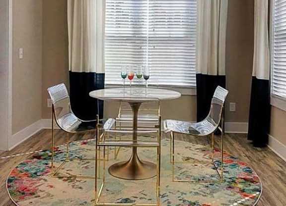 A dining room with a round table and chairs at Foxwood Apartments, Raleigh-Durham, NC