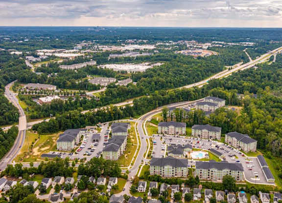 An aerial view of a large housing complex surrounded by trees. at Foxwood Apartments, Raleigh-Durham, North Carolina