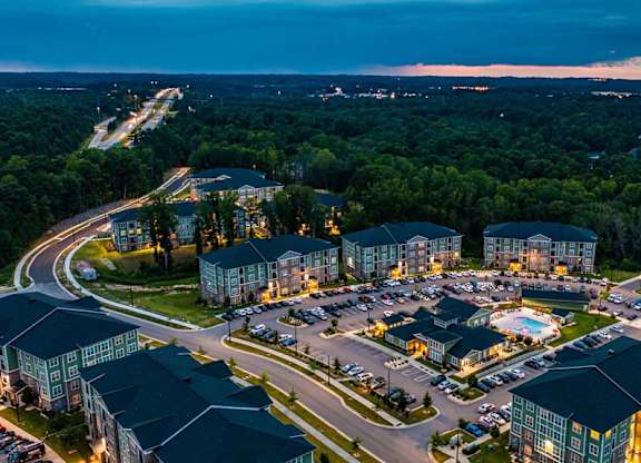A large resort with a swimming pool and a parking lot. at Foxwood Apartments, Raleigh-Durham, NC, 27616