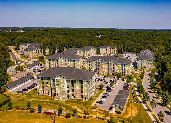 A large building complex with a parking lot in front at Foxwood Apartments, North Carolina, 27616