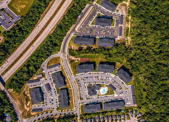 A bird's eye view of a residential area with a large building in the center at Foxwood Apartments, Raleigh-Durham
