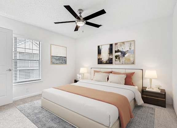 A bedroom with a large bed and a ceiling fan. at The Grayson Apartment Homes, Charlotte
