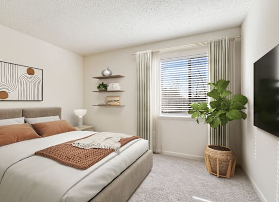 a bedroom with a large bed and a large plant in the corner of the room at Eastchester Ridge Apartments, High Point, 27262