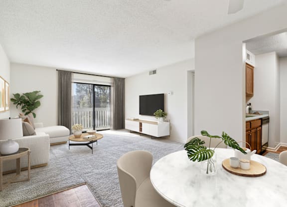a living room with a white table and chairs and a large sliding glass door leading at Eastchester Ridge Apartments, High Point, NC, 27262