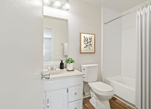 a bathroom with a white sink and toilet next to a white bathtub at Eastchester Ridge Apartments, High Point, NC, 27262