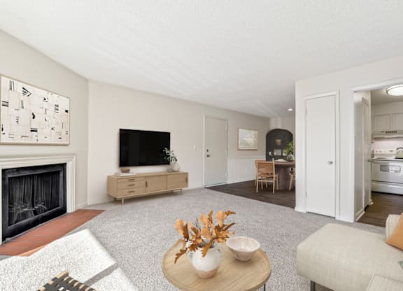 a living room with a fireplace and a dining room in the background at Eastchester Ridge Apartments, High Point, NC, 27262