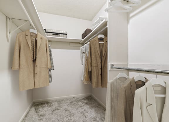 a walk in closet with white walls and a white mirrored medicine cabinet at Eastchester Ridge Apartments, High Point, NC, 27262