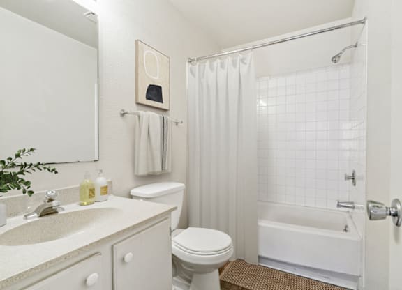 a bathroom with white fixtures and a white shower curtain at Eastchester Ridge Apartments, High Point, 27262