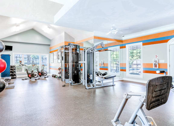 a home gym with exercise equipment and windows