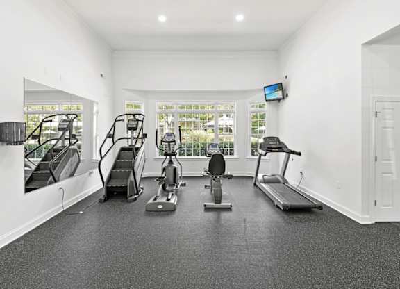 A spacious home gym with a variety of exercise equipment.