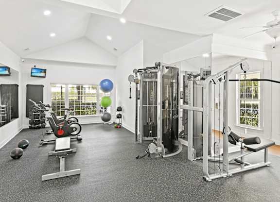 A spacious home gym with a variety of exercise equipment.