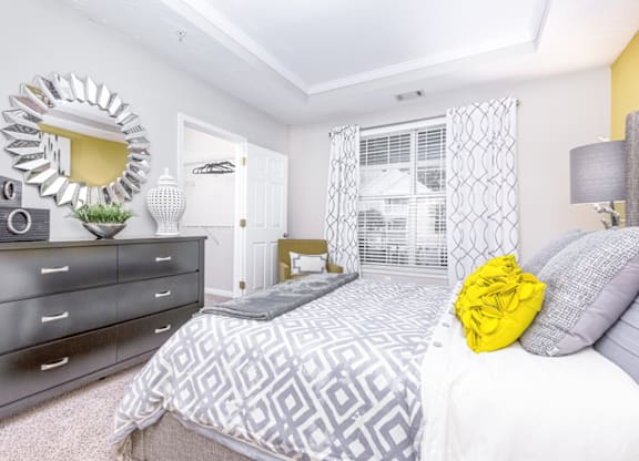 a bedroom with a bed and dresser