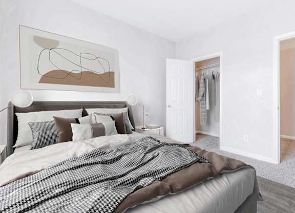 A bedroom with a large bed and a painting on the wall.