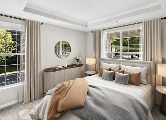 A bedroom with a large bed, a round mirror, and a window with blinds.