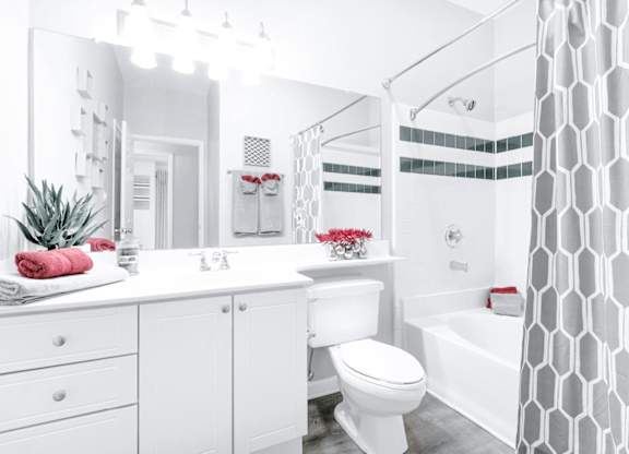 A white bathroom with a toilet, sink, and bathtub.