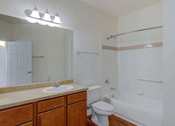 A white bathroom with a toilet, sink, and bathtub at Ethan Pointe Apartments, North Carolina, 27215