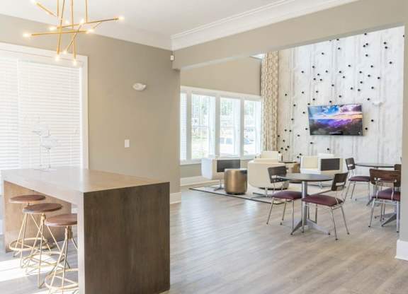 A modern kitchen with a bar area and a dining table set up at Foxwood Apartments, North Carolina