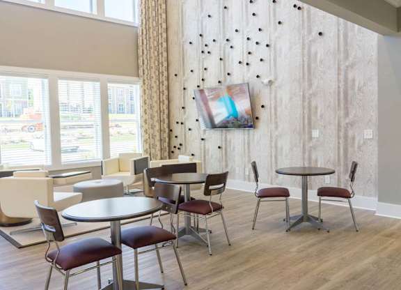 A room with a table and chairs and a painting on the wall at Foxwood Apartments, Raleigh-Durham