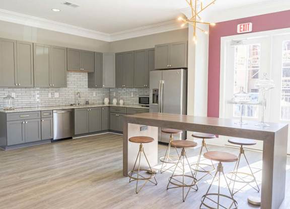 A kitchen with a bar area and stools at Foxwood Apartments, Raleigh-Durham