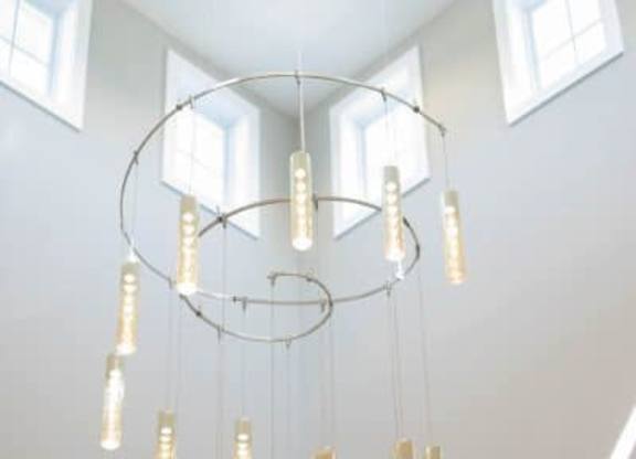 A chandelier with multiple lights hanging from the ceiling at Foxwood Apartments, North Carolina, 27616