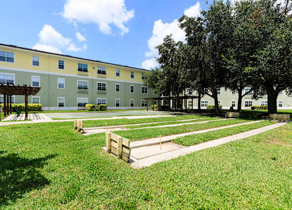 A building with a green lawn in front of it.