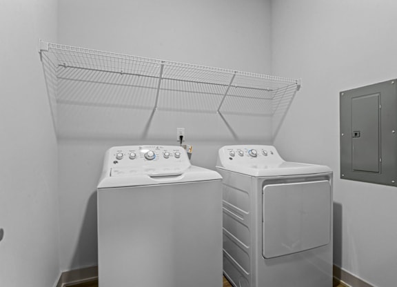 Two white front load washing machines in a laundry room at Litchford 315 Apartments, Raleigh