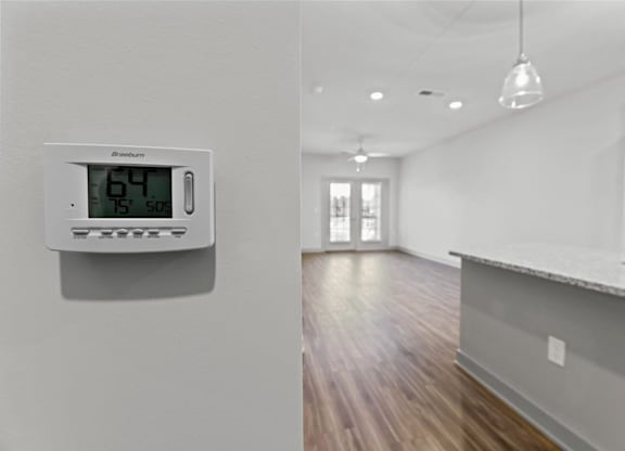 A digital thermostat shows the temperature as 64 degrees at Litchford 315 Apartments, North Carolina, 27615