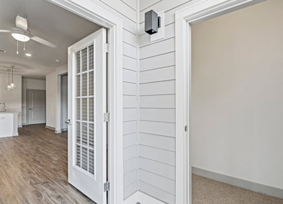 A white door with a window is open to a room with wood flooring at Litchford 315 Apartments, Raleigh, NC, 27615