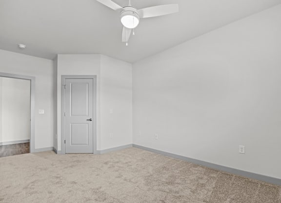 A room with a ceiling fan and two doors at Litchford 315 Apartments, North Carolina