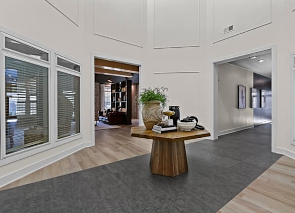 A modern office space with a wooden table and chairs in the center at Litchford 315 Apartments, Raleigh, North Carolina