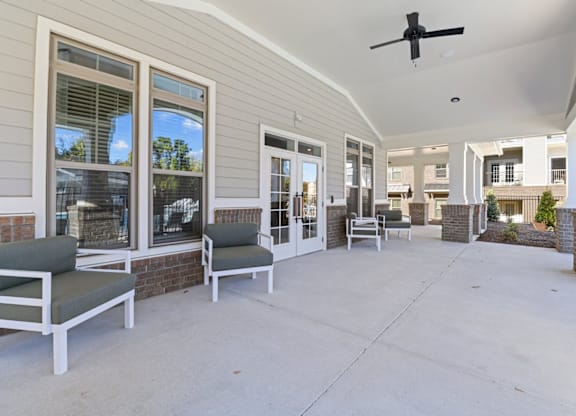 A patio with a ceiling fan and chairs at Litchford 315 Apartments, North Carolina