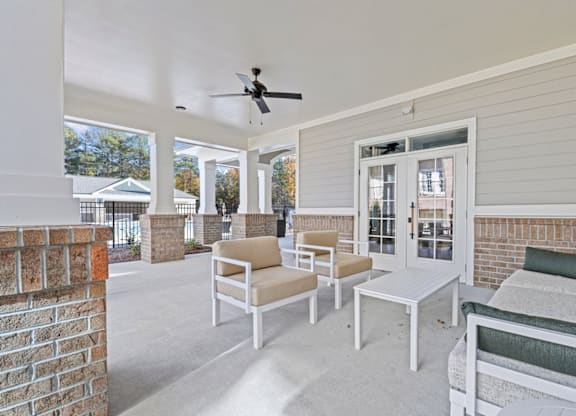A white patio with furniture and a ceiling fan at Litchford 315 Apartments, Raleigh, 27615