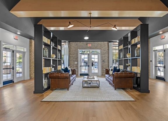 A spacious living room with a large rug in the center and a fireplace in the background at Litchford 315 Apartments, Raleigh