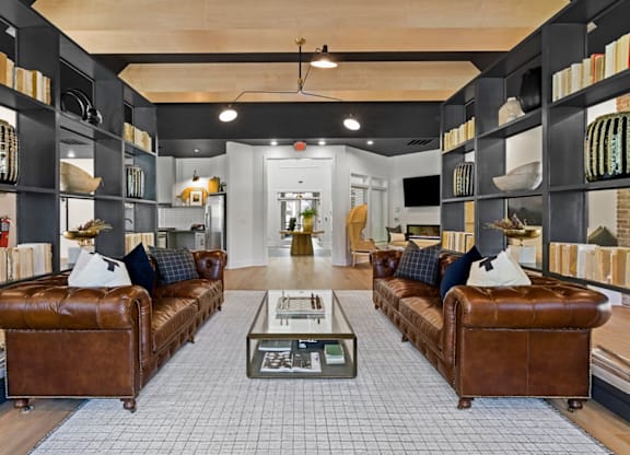 A living room with two brown leather couches and a coffee table in the center at Litchford 315 Apartments, Raleigh, NC