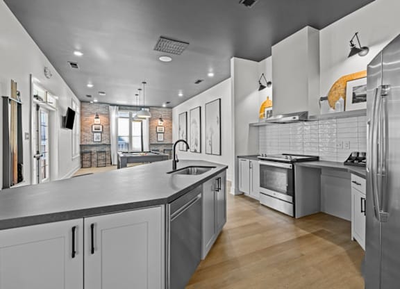 A modern kitchen with stainless steel appliances and wooden floors at Litchford 315 Apartments, Raleigh, NC, 27615