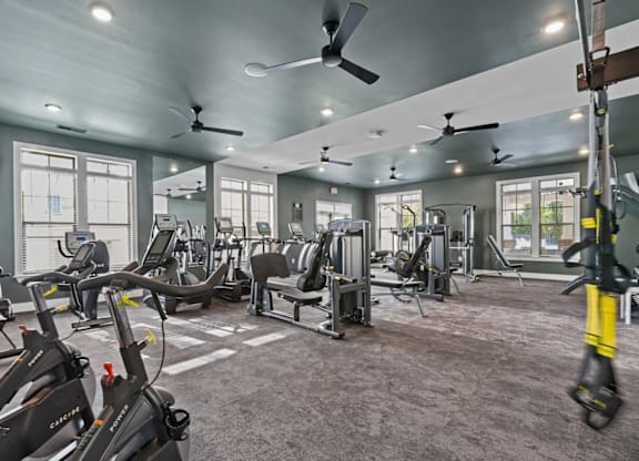A gym with a variety of exercise equipment including treadmills, stationary bikes, and weight machines at Litchford 315 Apartments, Raleigh, 27615