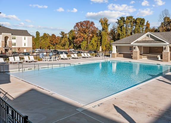 A large outdoor swimming pool with a building in the background at Litchford 315 Apartments, Raleigh