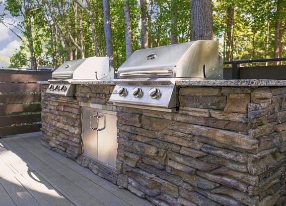 A stone wall with a grill on top at Madison Southpark Apartment Homes, Charlotte, 28226
