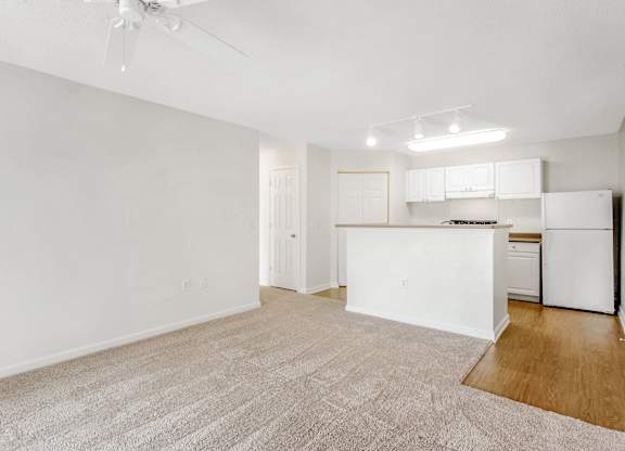 A white kitchen with a refrigerator, stove, and cabinets. at The Grayson Apartment Homes, Charlotte, North Carolina