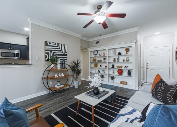 a living room with hardwood-style flooring and a ceiling fan