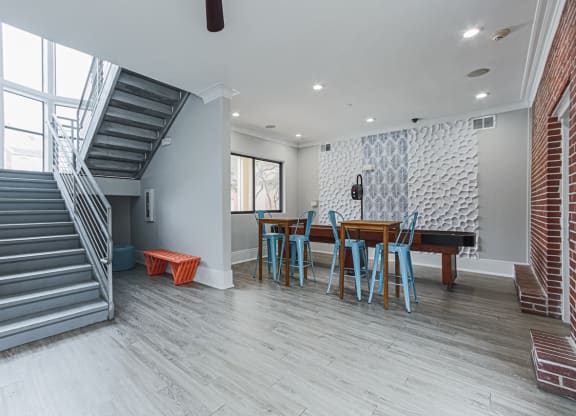 clubhouse lounge with a table and a staircase