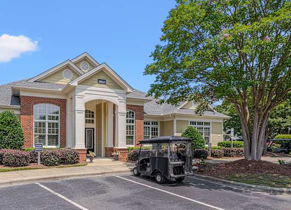 A house with a golf cart parked in front.