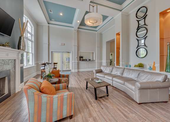 A living room with a fireplace and a striped chair.