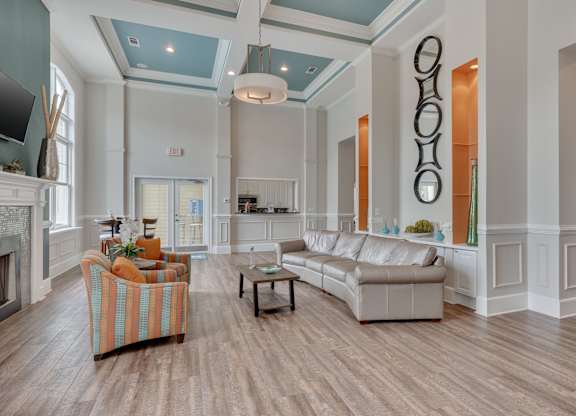 Clubhouse living room with a fireplace and a striped chair.