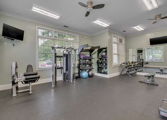 A spacious home gym with a variety of exercise equipment.