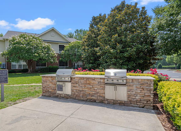 A brick wall with a grill on top of it.