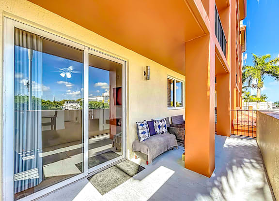 A balcony with a chair and pillows